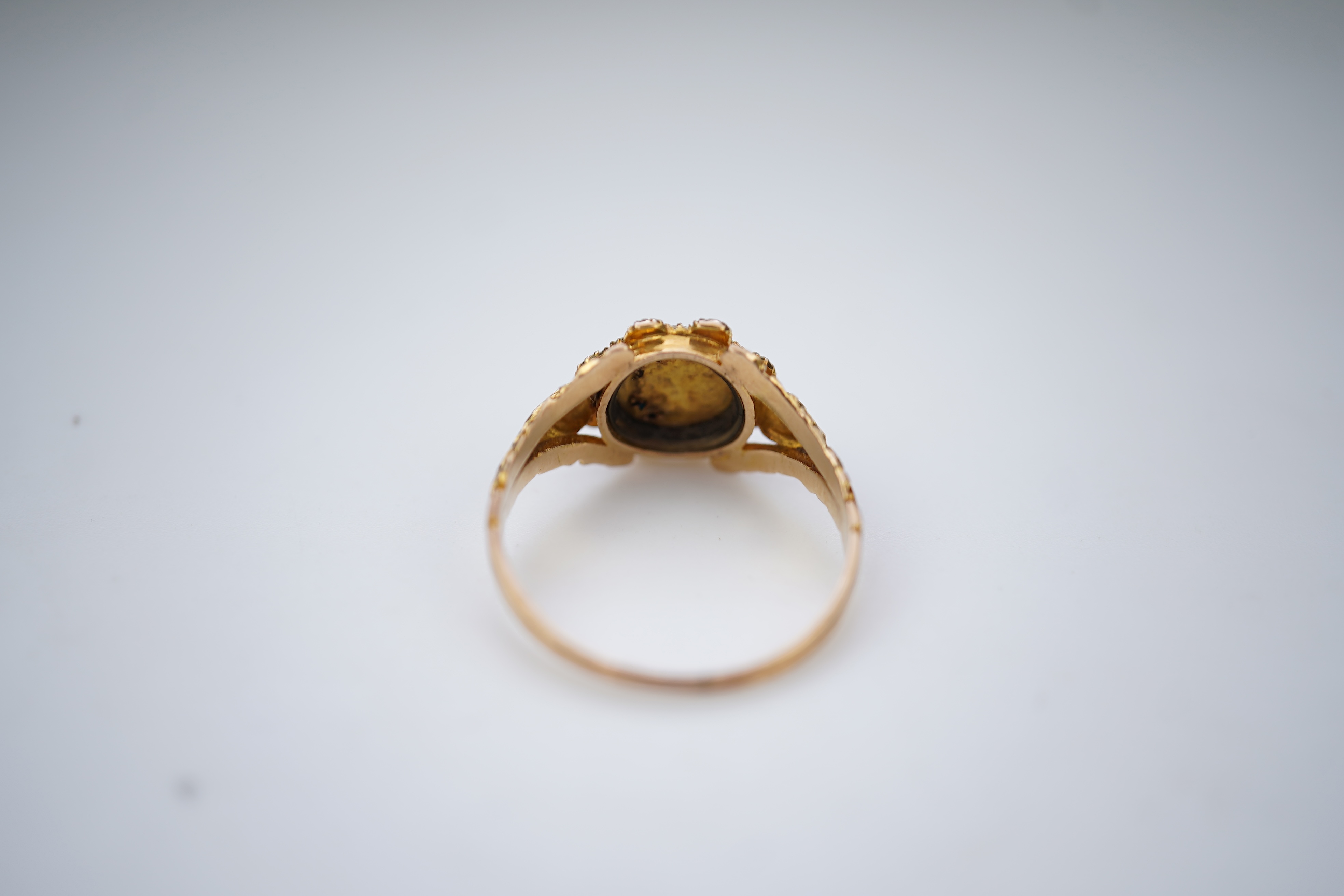A late Georgian garnet, pearl and turquoise ring, circa 1830